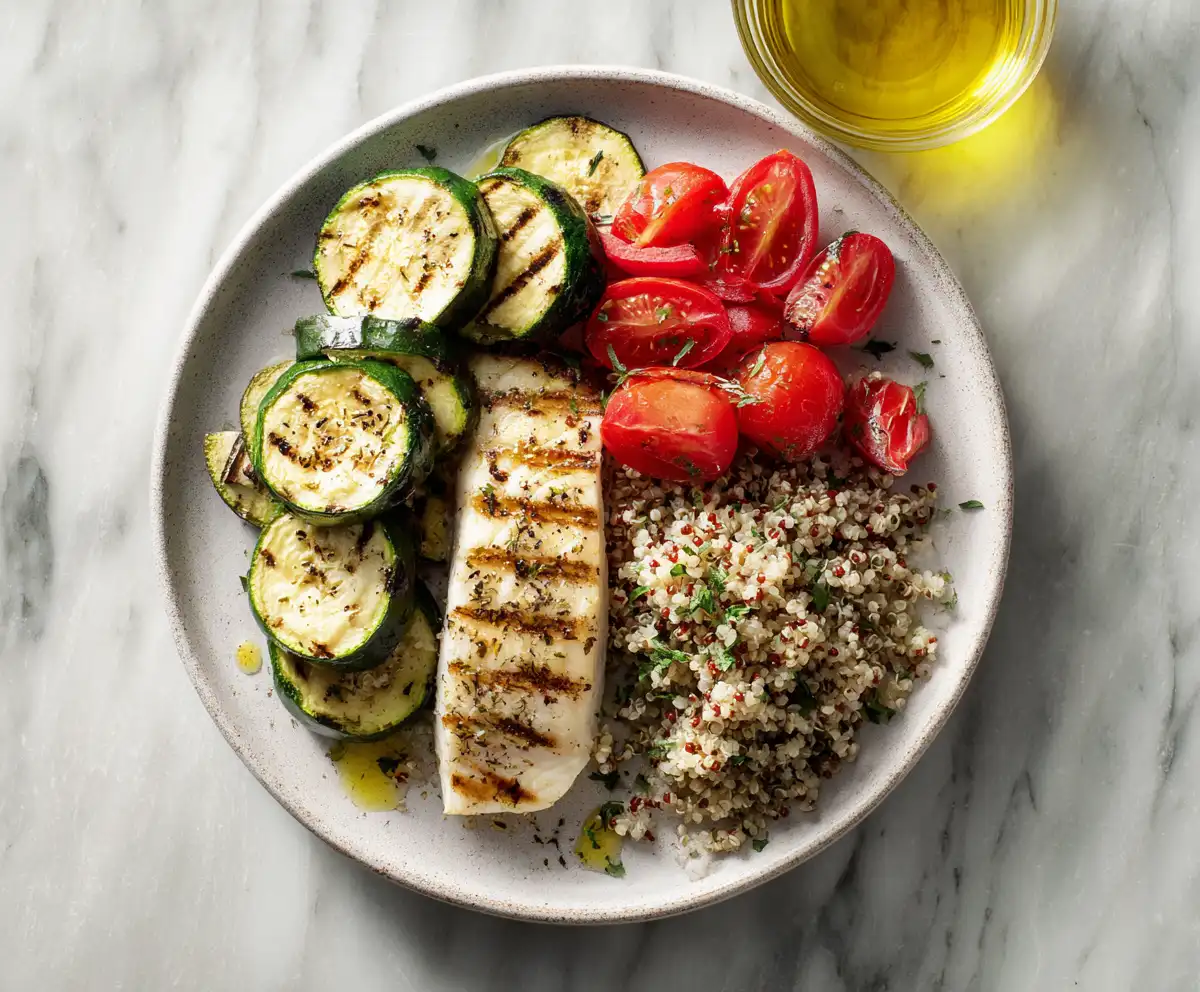 Balanced plate showing vegetables, grains, and fish for a Mediterranean diet meal plan