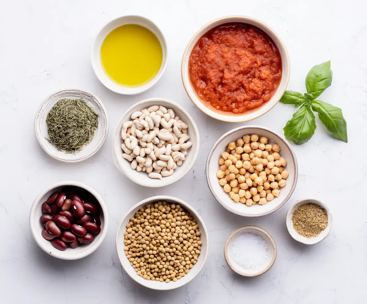 mediterranean pantry flatlay with olive oil beans chickpeas tomato sauce and dried herbs