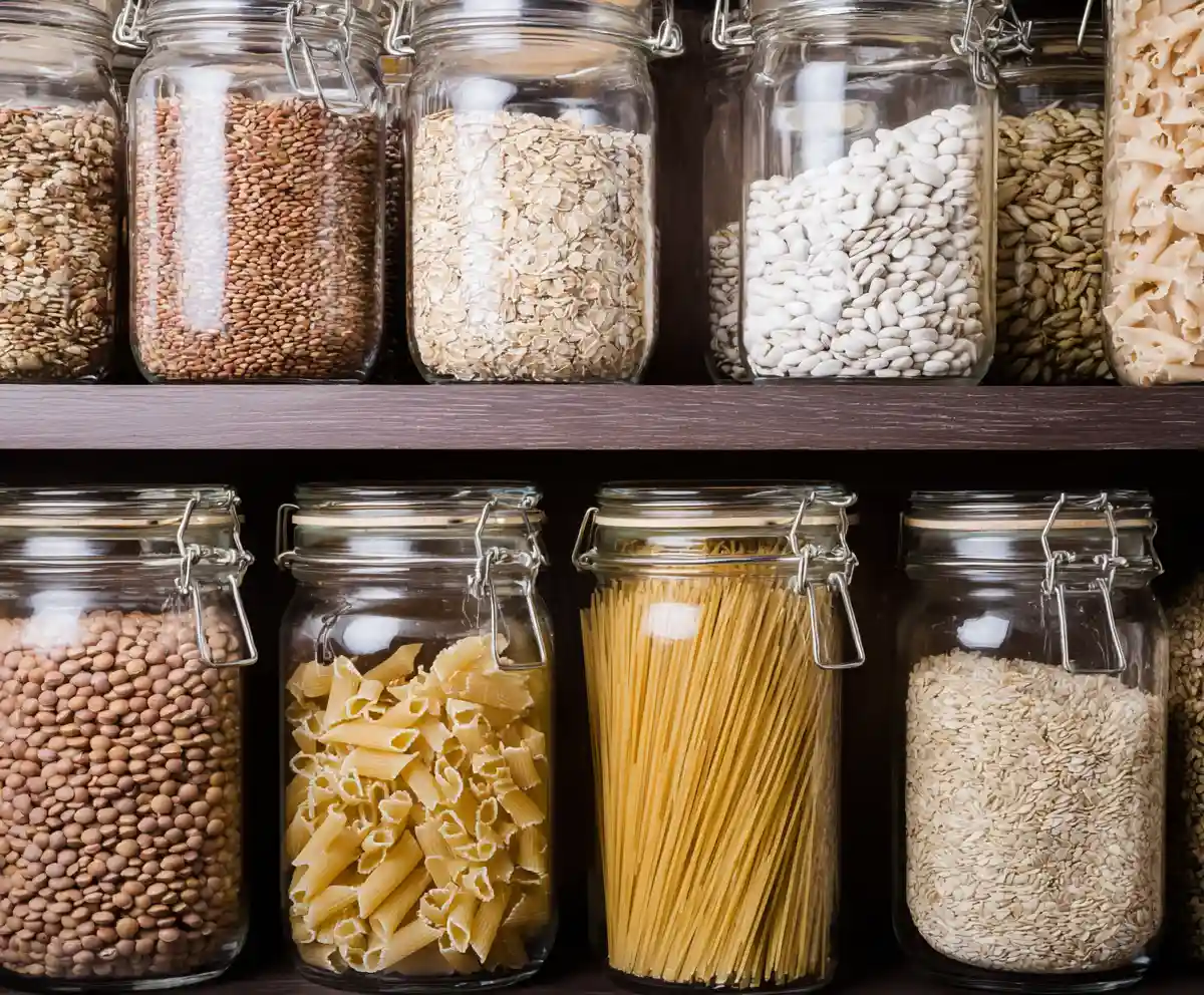 mediterranean pantry grains and legumes stored in tall glass jars on shelves